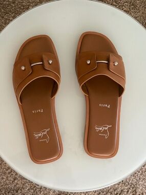 Christian Louboutin tan slides with red bottoms